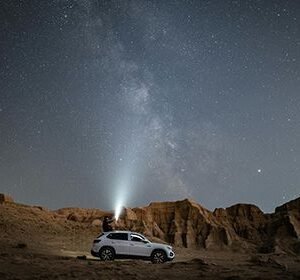 Man on SUV with flashlight HD Metal Poster